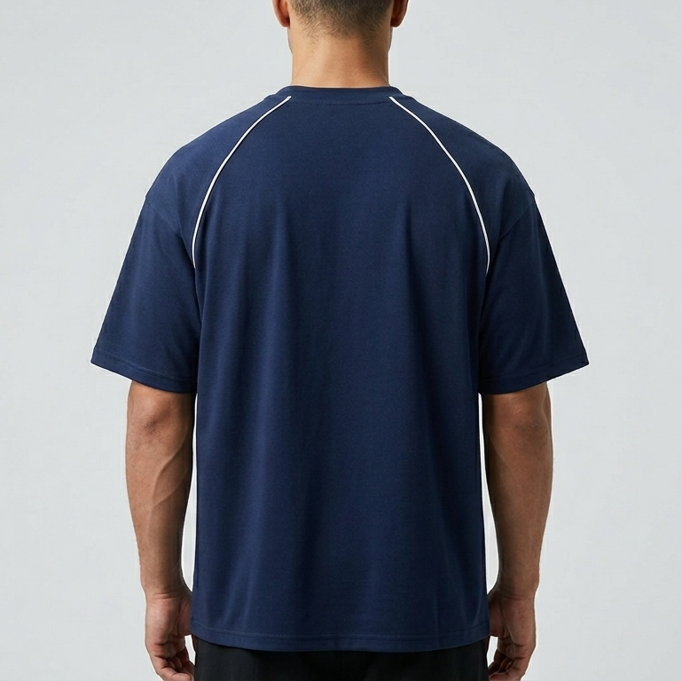 Person wearing a navy blue athletic shirt with white accents on a gray background