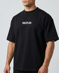 Man wearing a black t-shirt with 'DISCIPLINE' text on a gray background