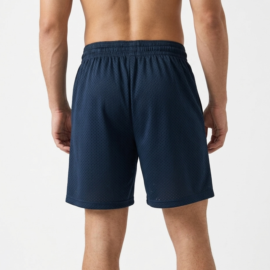 Navy blue athletic shorts worn by a person on a white background